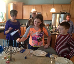 My sister read about Hanukkah while my niece Audree lit the Menorah candles, with Joe watching closely and my Dad and brother in the background.